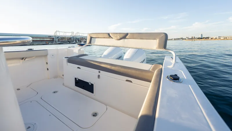  Yacht Photos Pics 2025 SeaWell 290XL boat interior with seating, overlooking calm waters and distant shoreline.