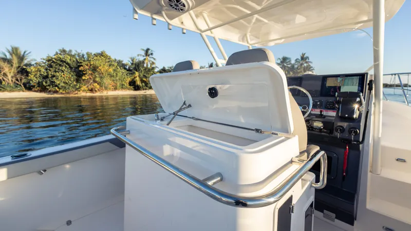  Yacht Photos Pics 2025 SeaWell 290XL boat interior with open storage, near tropical shoreline.