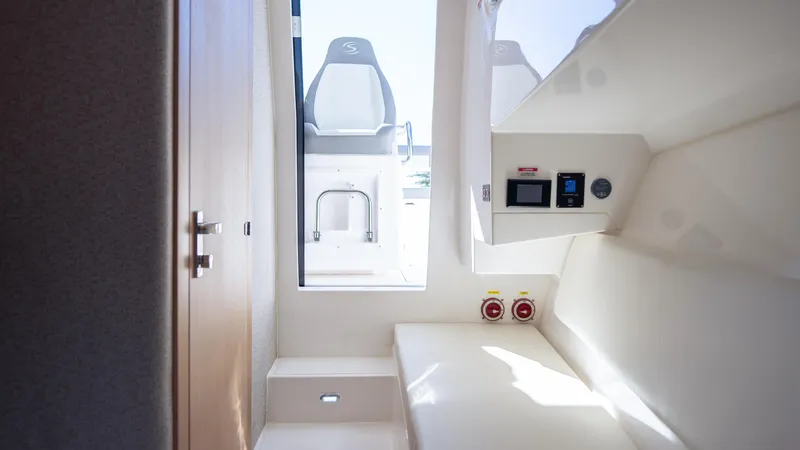  Yacht Photos Pics Interior cabin of 2025 SeaWell 290XL boat, featuring modern controls and seating.