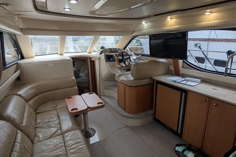 One Life Yacht Photos Pics Luxurious interior of 2004 Meridian 341 yacht with leather seating and modern helm.