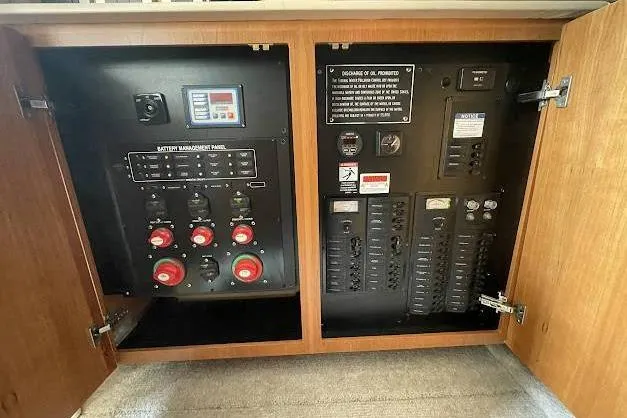 One Life Yacht Photos Pics Electrical control panel inside a 2004 Meridian 341 boat, featuring switches and management systems.
