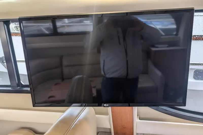 One Life Yacht Photos Pics LG TV inside 2004 Meridian 341 yacht, reflecting interior seating area.