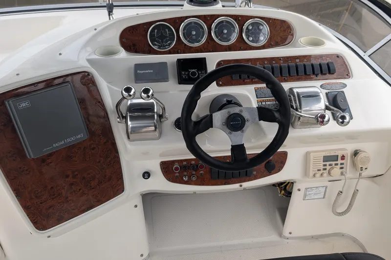 One Life Yacht Photos Pics 2004 Meridian 341 yacht helm with steering wheel, controls, and navigation instruments.