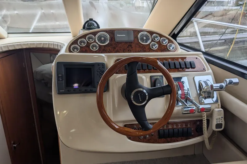One Life Yacht Photos Pics 2004 Meridian 341 yacht helm with steering wheel, controls, and navigation instruments.