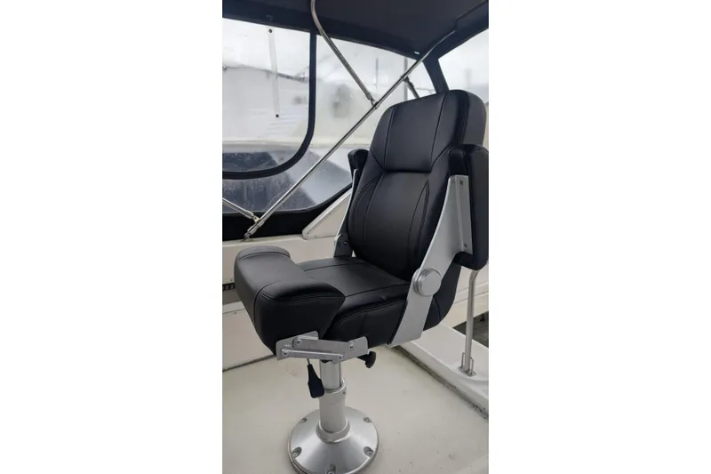 One Life Yacht Photos Pics Captain's chair on 2004 Meridian 341 yacht, featuring sleek black upholstery and sturdy metal frame.