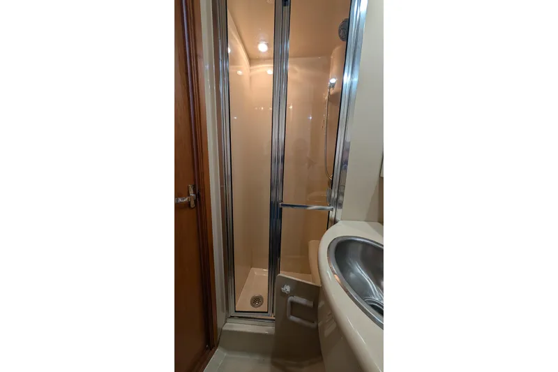 One Life Yacht Photos Pics Shower area in 2004 Meridian 341 yacht, featuring glass door and stainless steel sink.