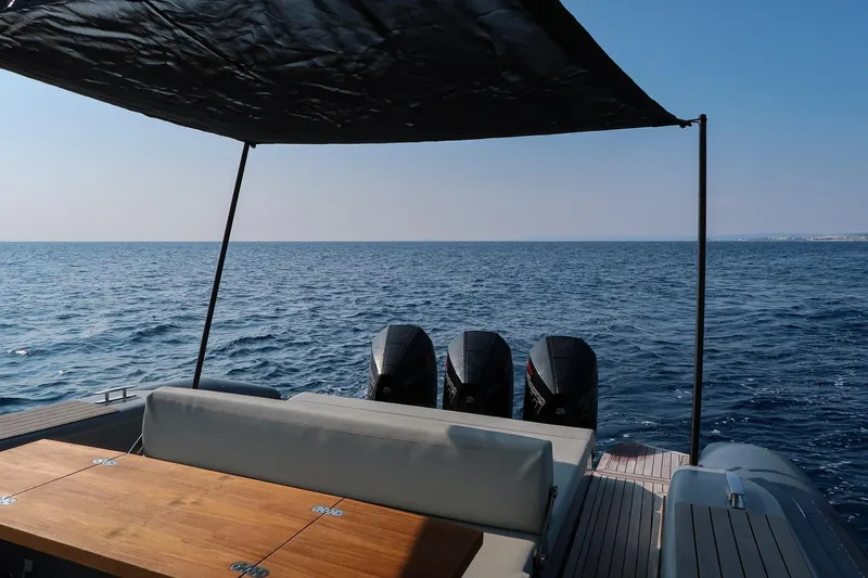  Yacht Photos Pics 2023 Pirelli 42 yacht with canopy, ocean view, and triple outboard motors.