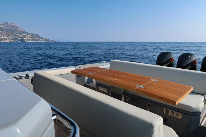  Yacht Photos Pics Luxury Pirelli 42 yacht deck with wooden table, scenic ocean view, 2023 model.