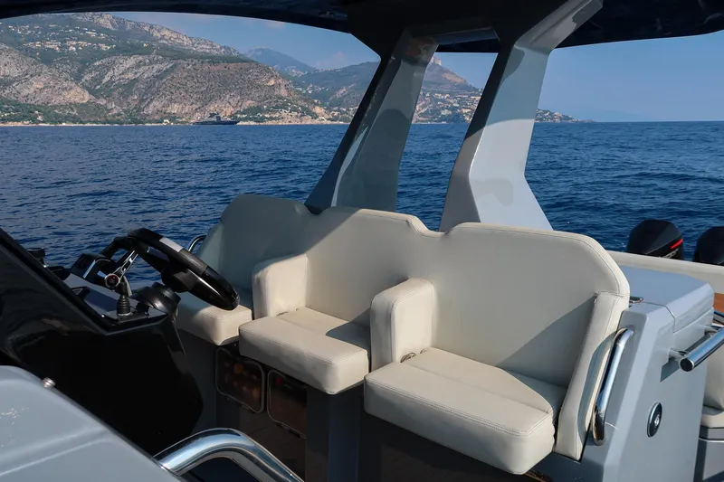  Yacht Photos Pics Cockpit of 2023 Pirelli 42 boat with scenic coastal view in the background.