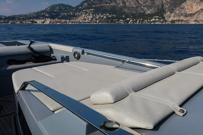  Yacht Photos Pics Luxurious 2023 Pirelli 42 yacht with sunbathing deck, scenic coastal backdrop.