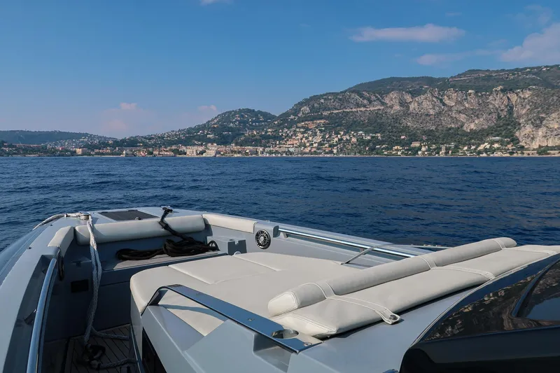  Yacht Photos Pics 2023 Pirelli 42 boat cruising on blue waters with scenic coastal backdrop.