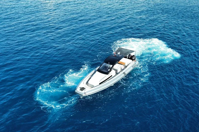  Yacht Photos Pics 2023 Pirelli 42 boat cruising on clear blue ocean waters.