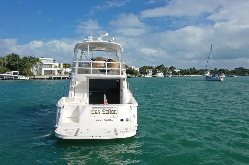  Yacht Photos Pics 2001 Sea Ray 480 Sedan Bridge yacht on turquoise water, Miami backdrop.