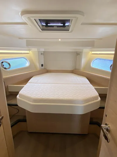  Yacht Photos Pics 2023 Beneteau Swift Trawler 41 Fly cabin with bed, portholes, and overhead hatch.