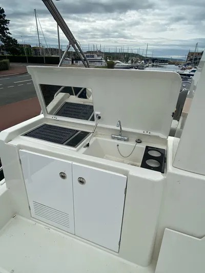  Yacht Photos Pics 2023 Beneteau Swift Trawler 41 Fly outdoor kitchenette with sink and storage.