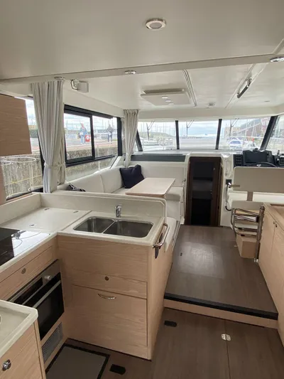  Yacht Photos Pics Interior of 2023 Beneteau Swift Trawler 41 Fly, featuring modern kitchen and spacious seating area.