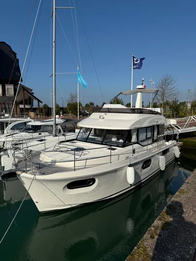  Yacht Photos Pics 2023 Beneteau Swift Trawler 41 Fly moored at a marina under clear skies.