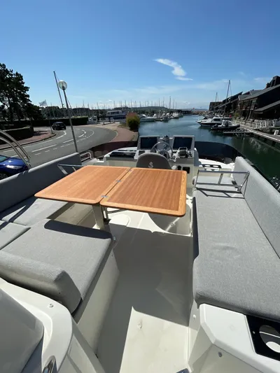 Yacht Photos Pics 2023 Beneteau Swift Trawler 41 Fly, spacious deck with seating and table, docked at marina.