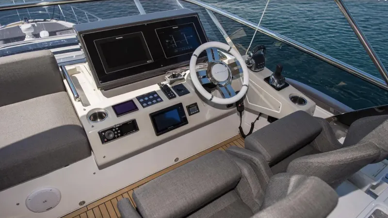  Yacht Photos Pics Cockpit of 2018 Azimut S7 yacht with modern navigation equipment and plush seating.