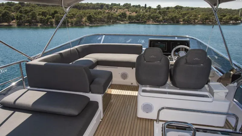  Yacht Photos Pics Luxurious 2018 Azimut S7 yacht deck with seating and steering, overlooking serene waters.