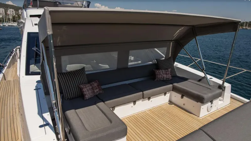  Yacht Photos Pics 2018 Azimut S7 yacht with shaded deck seating, featuring cushions and a sleek design.