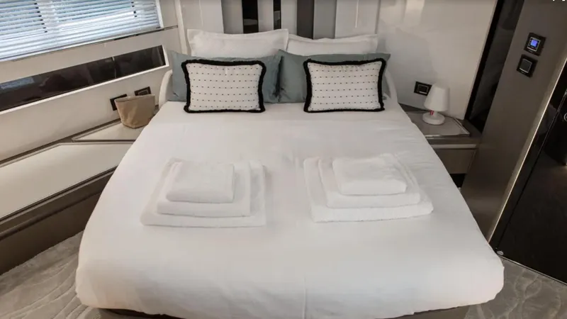  Yacht Photos Pics Luxurious bedroom interior of 2018 Azimut S7 yacht with neatly arranged bed and pillows.