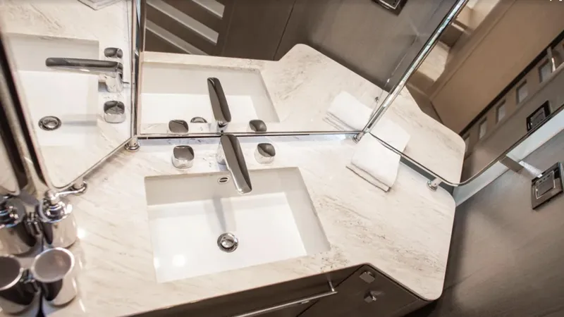  Yacht Photos Pics Luxurious bathroom sink in 2018 Azimut S7 yacht with marble countertop and modern fixtures.