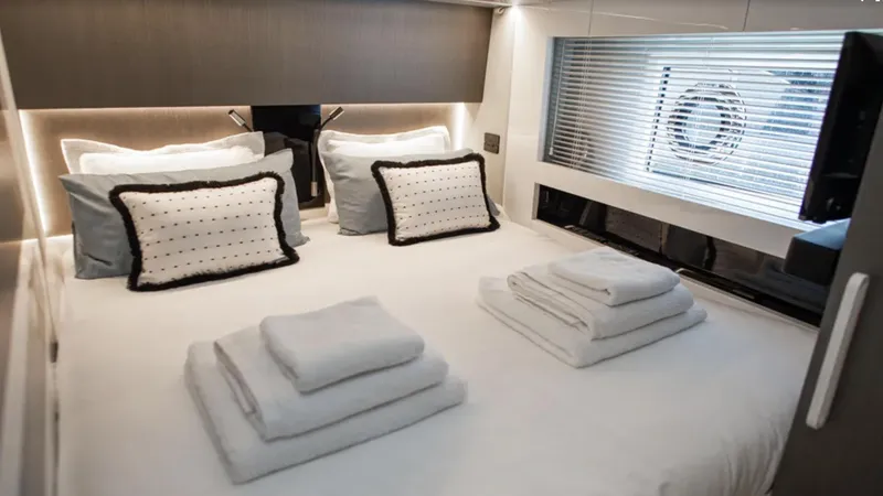  Yacht Photos Pics Luxurious bedroom interior of 2018 Azimut S7 yacht with neatly arranged linens and modern decor.