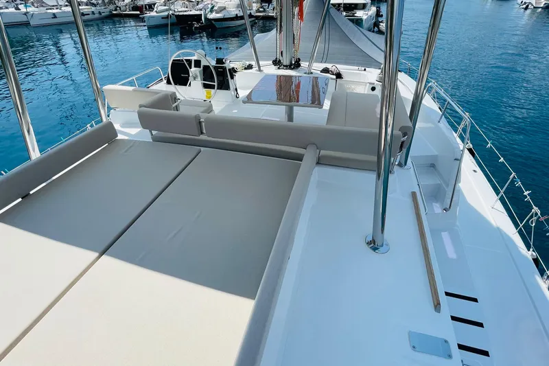  Yacht Photos Pics Luxurious 2025 Bali 4.6 yacht deck with seating and sunbathing area in marina.