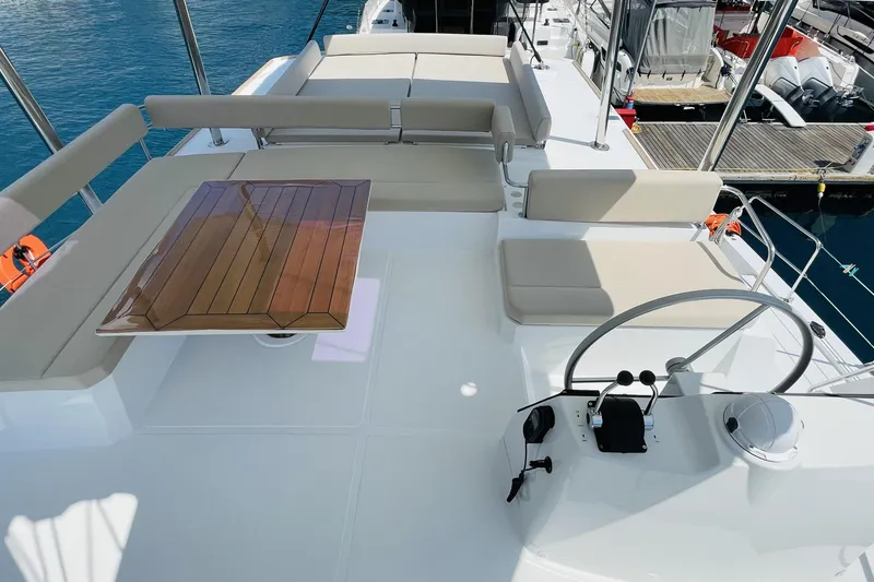  Yacht Photos Pics Luxurious 2025 Bali 4.6 yacht deck with seating and steering, docked at marina.