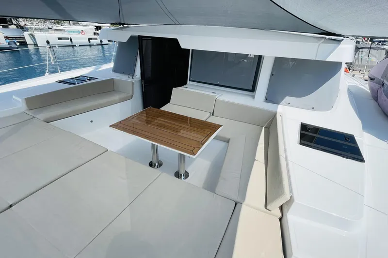  Yacht Photos Pics Luxurious 2025 Bali 4.6 yacht interior with spacious seating and elegant wooden table.