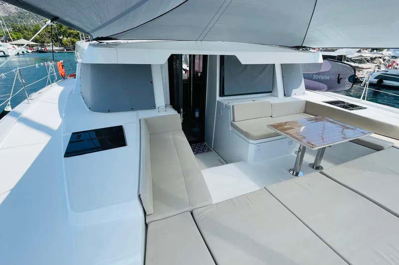  Yacht Photos Pics Luxurious Bali 4.6 catamaran deck with seating and table, docked in a marina, 2025 model.