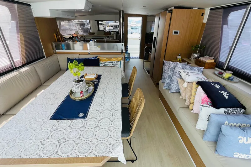  Yacht Photos Pics Luxurious interior of 2025 Bali 4.6 yacht with elegant dining area and cozy seating.