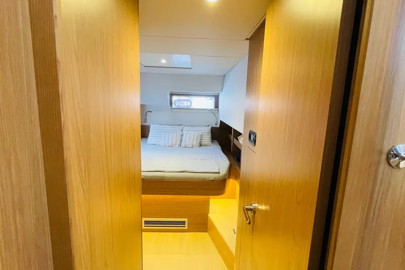  Yacht Photos Pics Interior cabin of 2025 Bali 4.6 yacht with cozy bed and wooden finish.