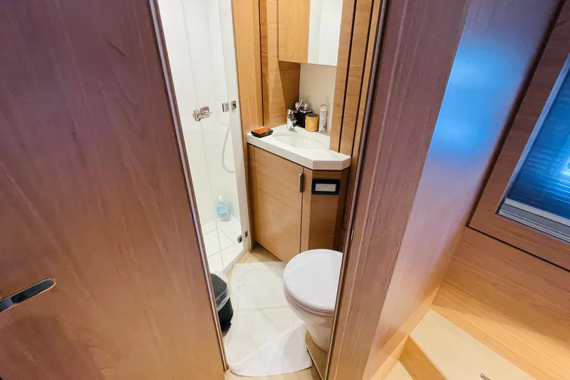  Yacht Photos Pics Modern bathroom interior in 2025 Bali 4.6 yacht, featuring wood accents and compact design.