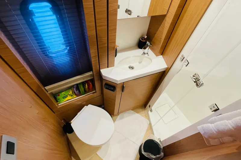  Yacht Photos Pics Compact bathroom in 2025 Bali 4.6 model, featuring modern fixtures and wooden cabinetry.