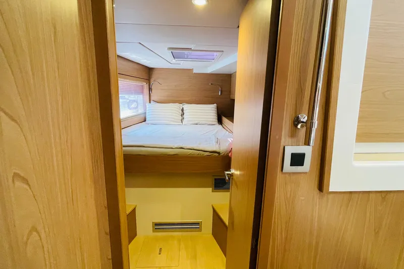  Yacht Photos Pics Cozy bedroom interior in 2025 Bali 4.6 yacht with wooden finish and skylight.