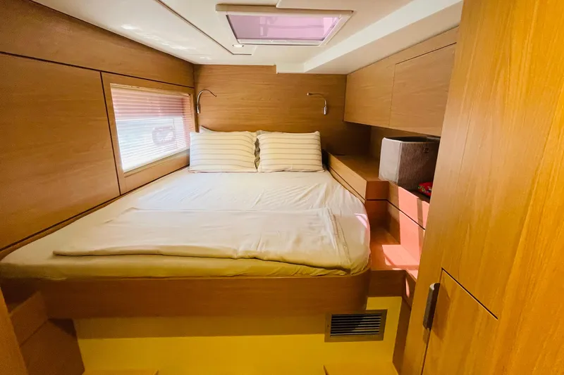  Yacht Photos Pics Luxurious cabin interior of 2025 Bali 4.6 yacht with cozy bed and wooden finish.