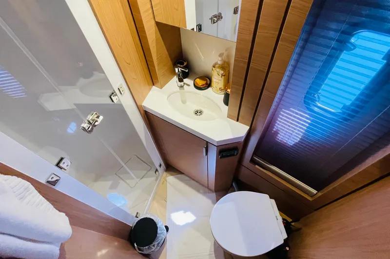  Yacht Photos Pics Modern bathroom in 2025 Bali 4.6 yacht with sleek wood finishes and compact design.