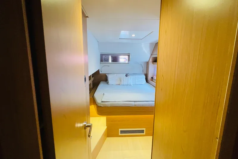  Yacht Photos Pics Cozy bedroom interior of 2025 Bali 4.6 yacht with wooden finish and comfortable bed.