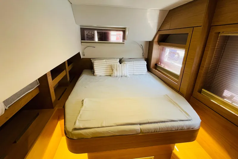  Yacht Photos Pics Luxurious cabin interior of 2025 Bali 4.6 yacht with cozy bed and wooden accents.