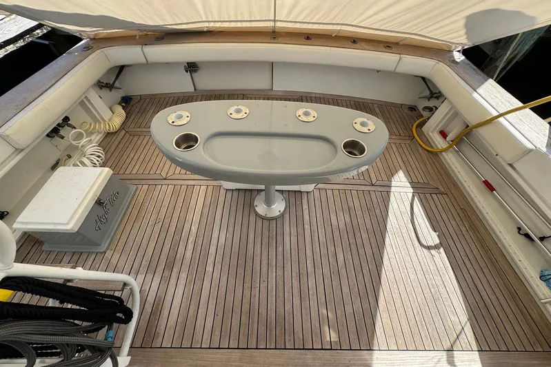 High Tide Yacht Photos Pics 1988 Buddy Davis 47 Convertible boat deck with fishing table and teak flooring.