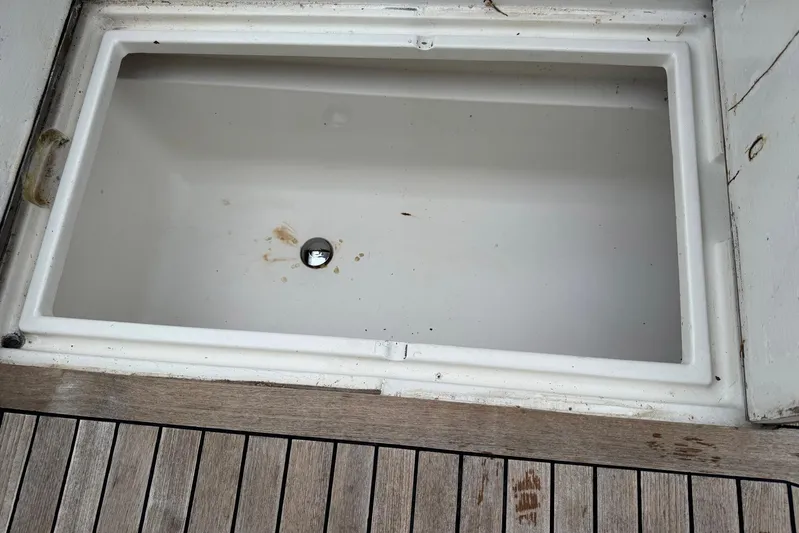 High Tide Yacht Photos Pics Empty storage compartment on 1988 Buddy Davis 47 Convertible boat deck.