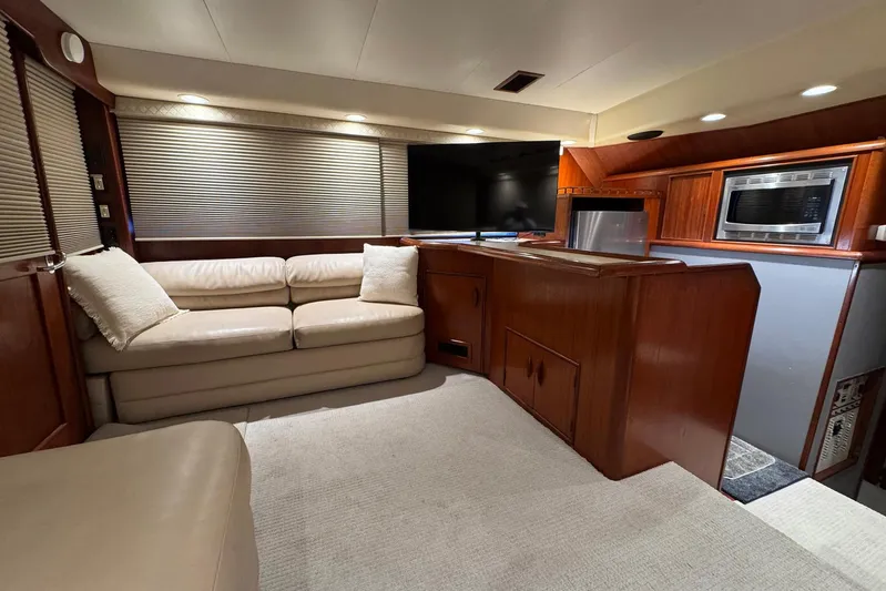 High Tide Yacht Photos Pics Luxurious interior of a 1988 Buddy Davis 47 Convertible yacht with leather seating and modern amenities.