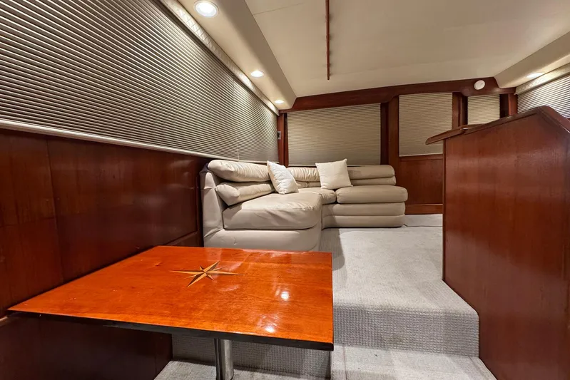 High Tide Yacht Photos Pics Luxurious interior of 1988 Buddy Davis 47 Convertible yacht with plush seating and wooden accents.