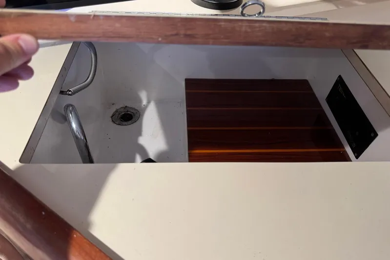 High Tide Yacht Photos Pics Open compartment on 1988 Buddy Davis 47 Convertible boat, showing interior details.