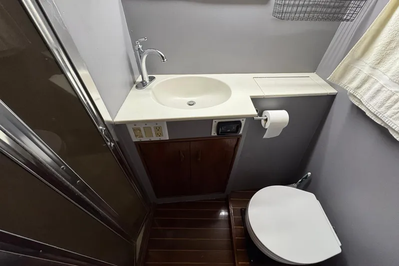 High Tide Yacht Photos Pics Bathroom interior of 1988 Buddy Davis 47 Convertible yacht, featuring sink and toilet.