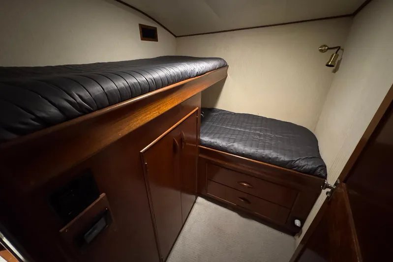 High Tide Yacht Photos Pics 1988 Buddy Davis 47 Convertible cabin with wooden bunk beds and storage drawers.