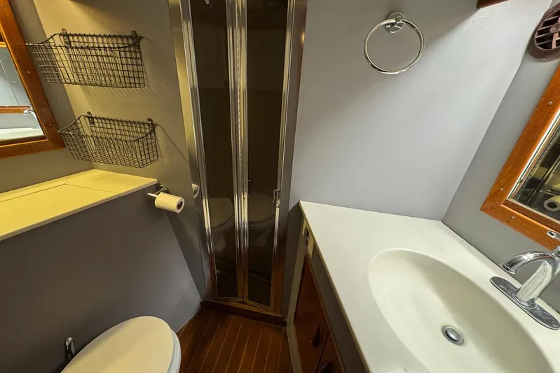 High Tide Yacht Photos Pics Bathroom interior of 1988 Buddy Davis 47 Convertible yacht, featuring shower and sink.