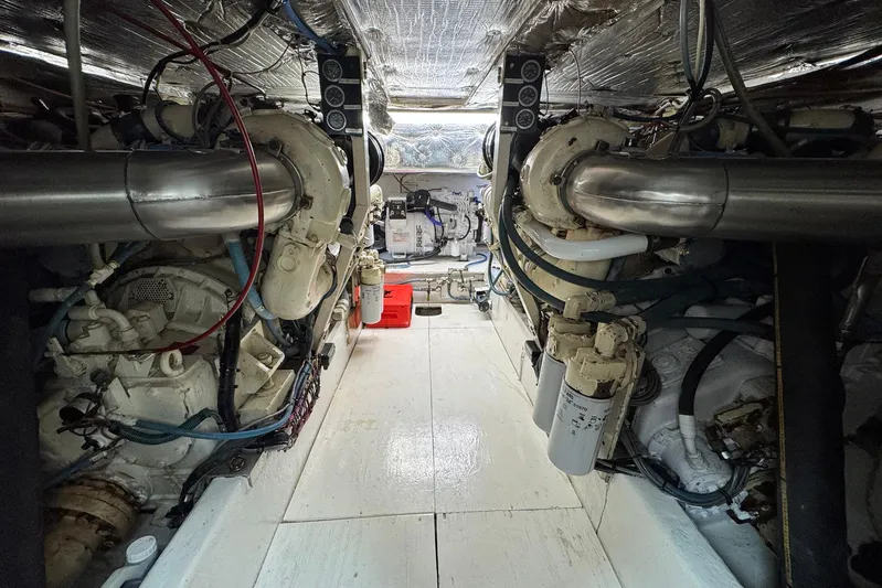 High Tide Yacht Photos Pics Engine room of 1988 Buddy Davis 47 Convertible with visible machinery and piping.